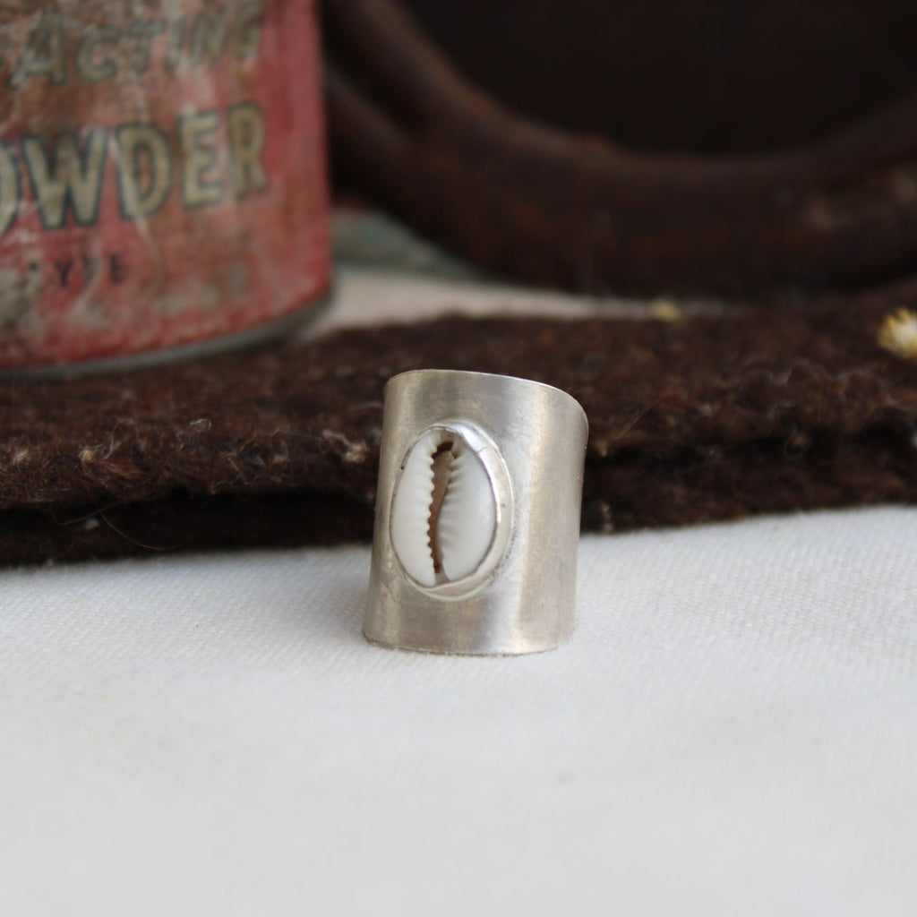 Close-up of a metal cylindrical object with a screw design on a textured background