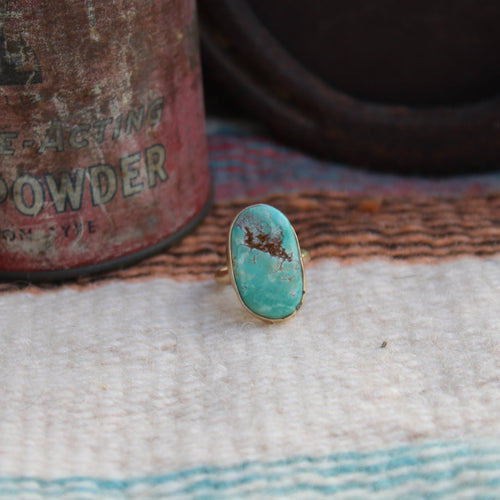 Turquoise stone on a textured fabric background